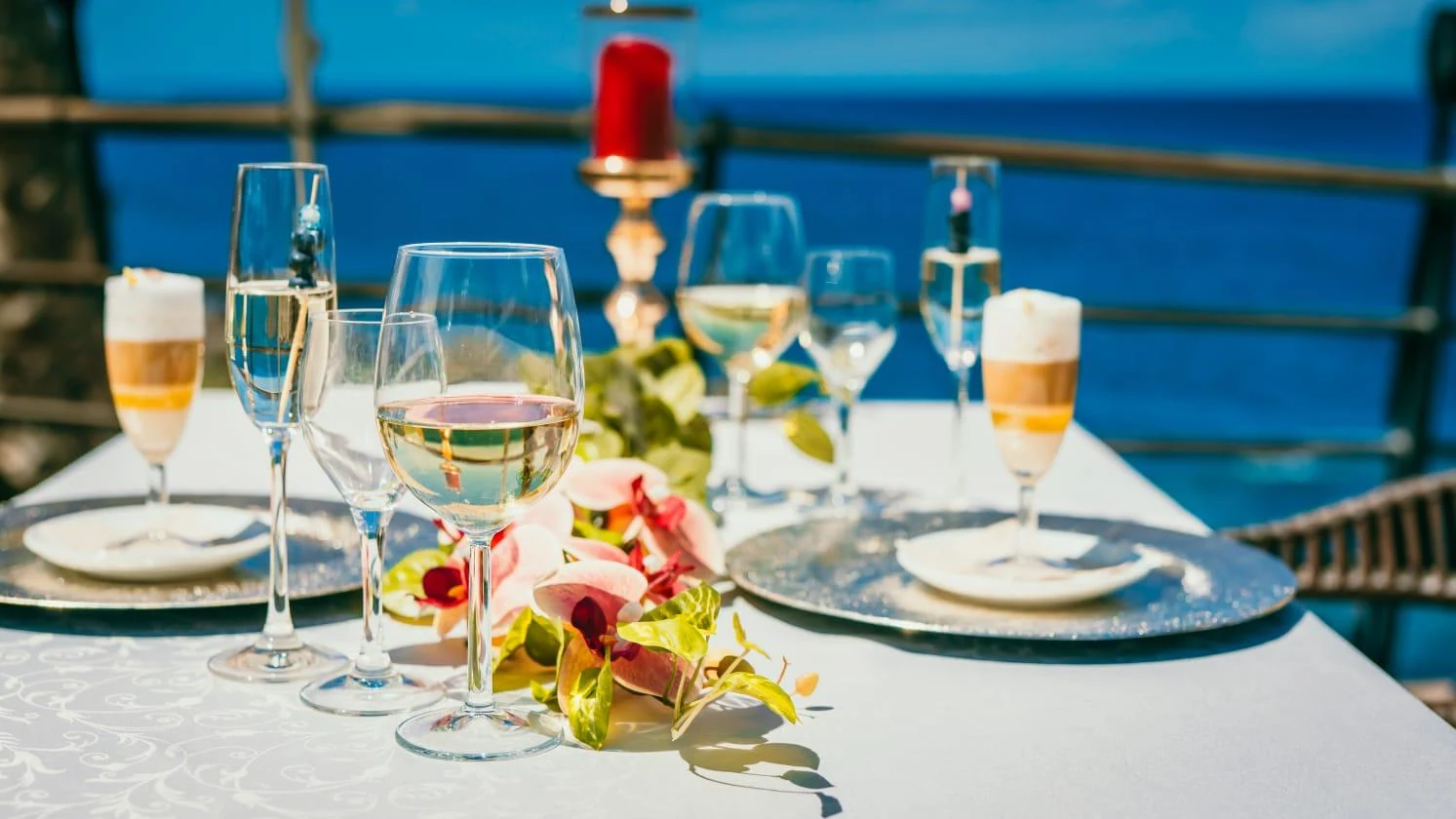 A table set with wine glasses on the Eulenspiegel Tenerife terrace overlooking the sea